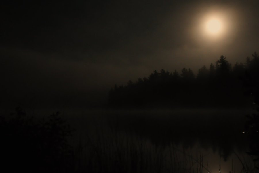 Moon breaks through the fog in the Boundary Waters.